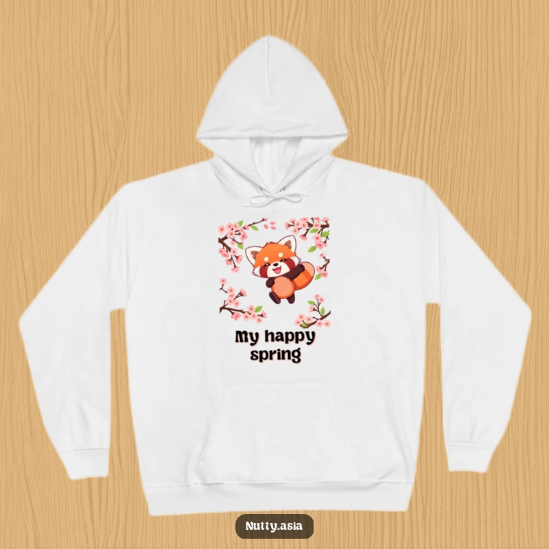 Cozy funny red panda leaping through blossoms, a warm and playful hoodie.
